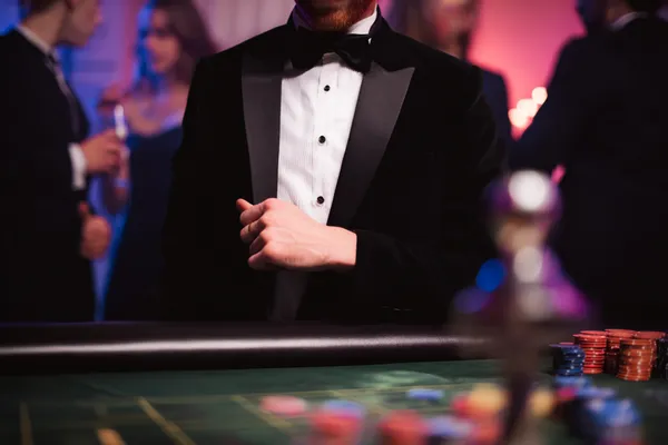 A young woman relaxing with her phone while dynamic casino elements float around her, illustrating the smooth mobile experience offered by the RK888 app.