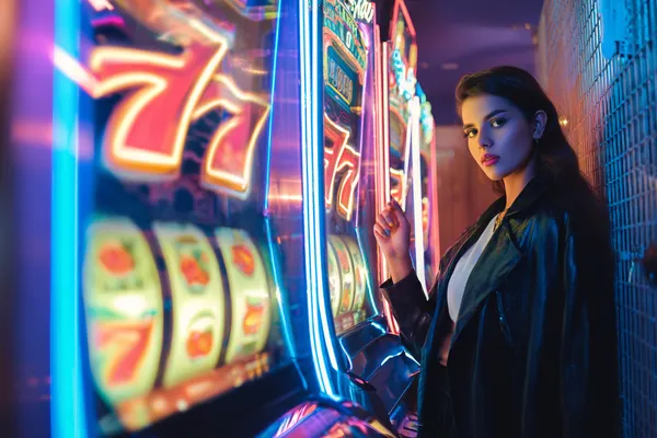 A glamorous woman holding casino chips in a neon-lit environment, representing the premium online casino atmosphere of RK888.
